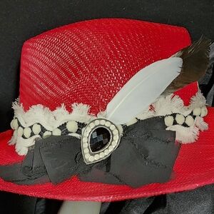 New, red straw hat with original decorations.